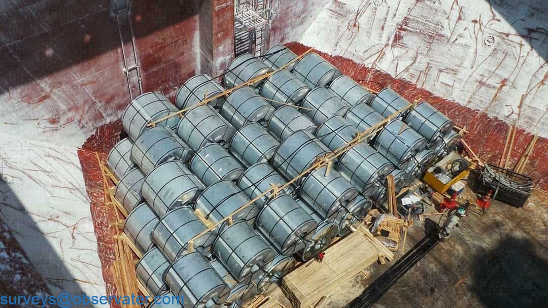 Marine surveyor inspecting cargo with a clipboard